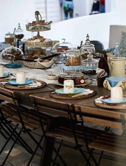 Breakfast table set with plates and cups.